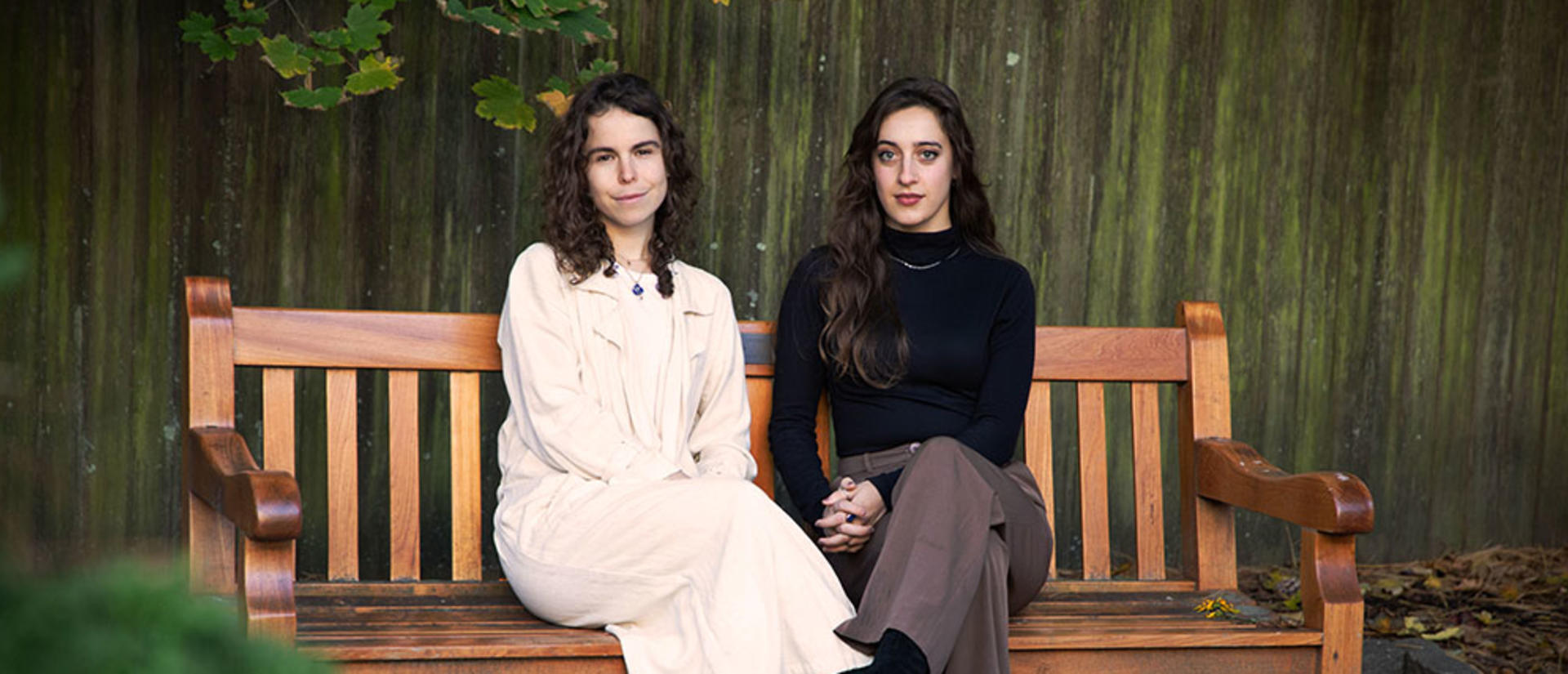 Paula Ortiz and Lia Pikus sitting on a bench in the CSWR courtyard. Photo: Alex Bayer