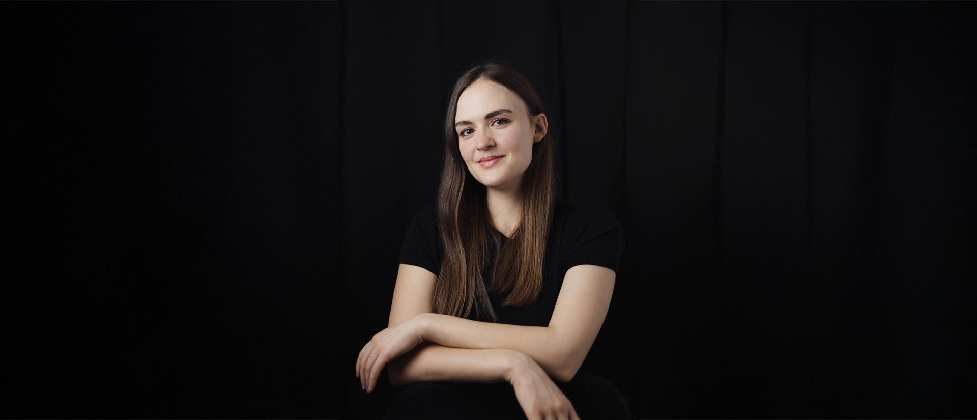 Jenna Carson poses for photo against black backdrop