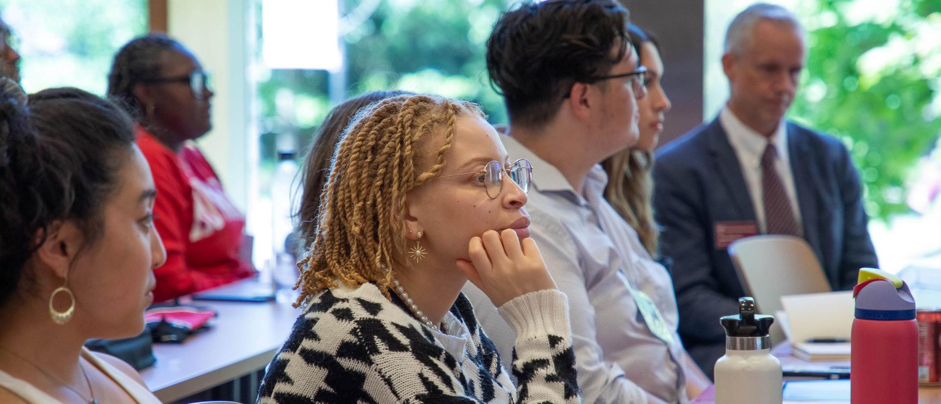 Candice Mulinda , seated, listens to a presentation in the James Room during DivEx 2023