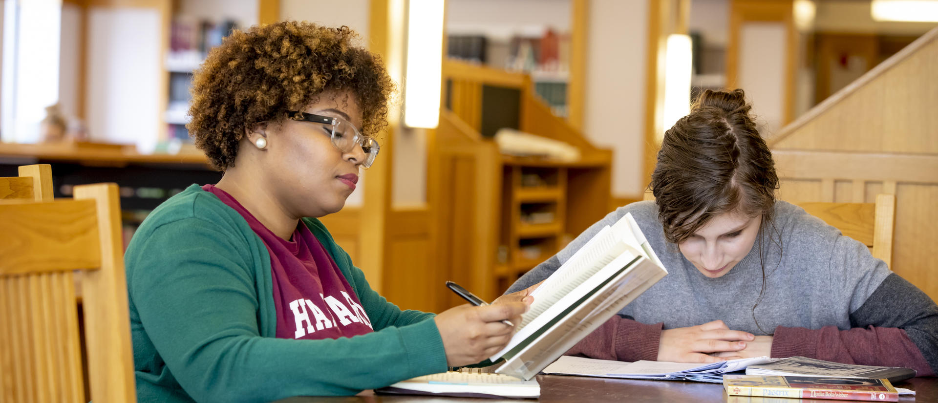 Two HDS students study in the library
