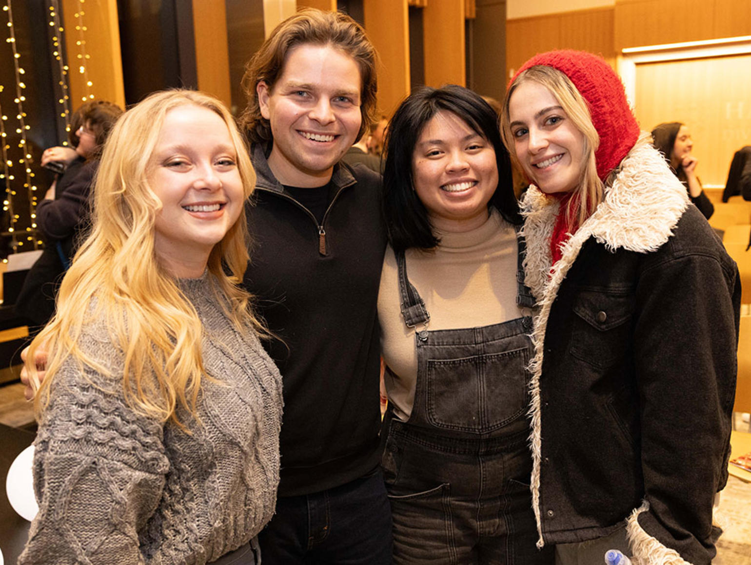 Four students posing together before an event