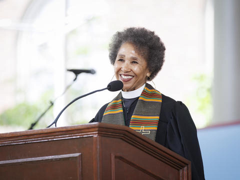 a person in clergy garments speaks at a podium