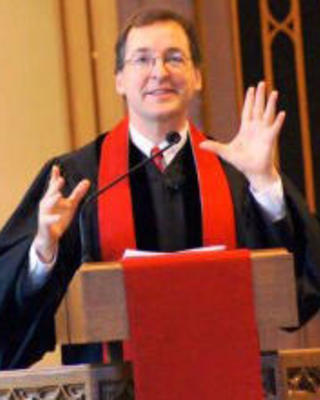 The Rev. Burns Stanfield speaks from a pulpit