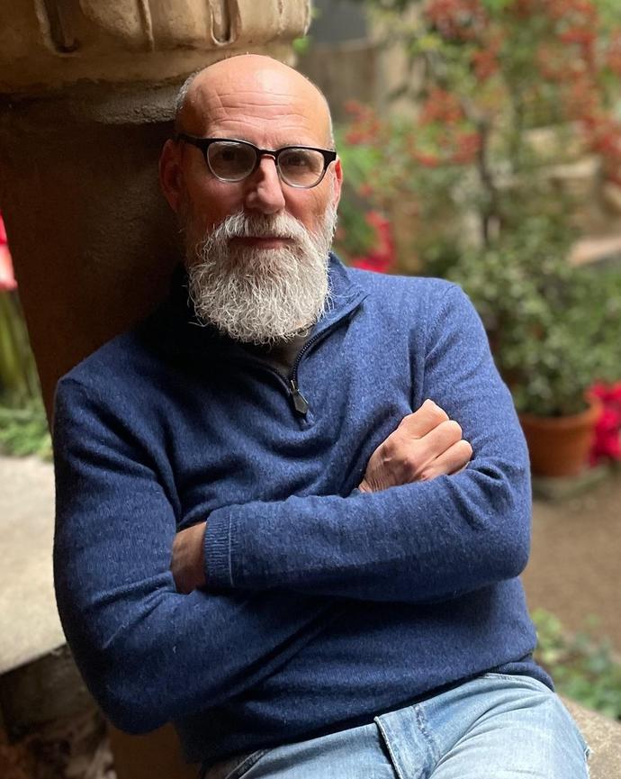 Shaul Magid sitting on a bench at a museum